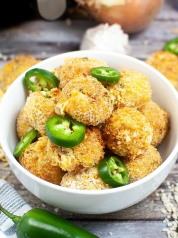 Bowl of Air Fryer Jalapeno Poppers with fresh jalapeno slices