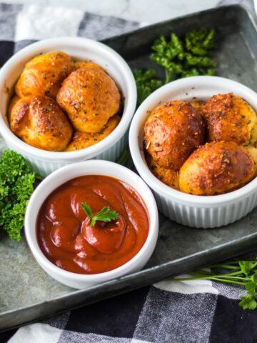 Air Fryer Pull Apart Pizza Bread in white ramekins served with a bowl of marinara