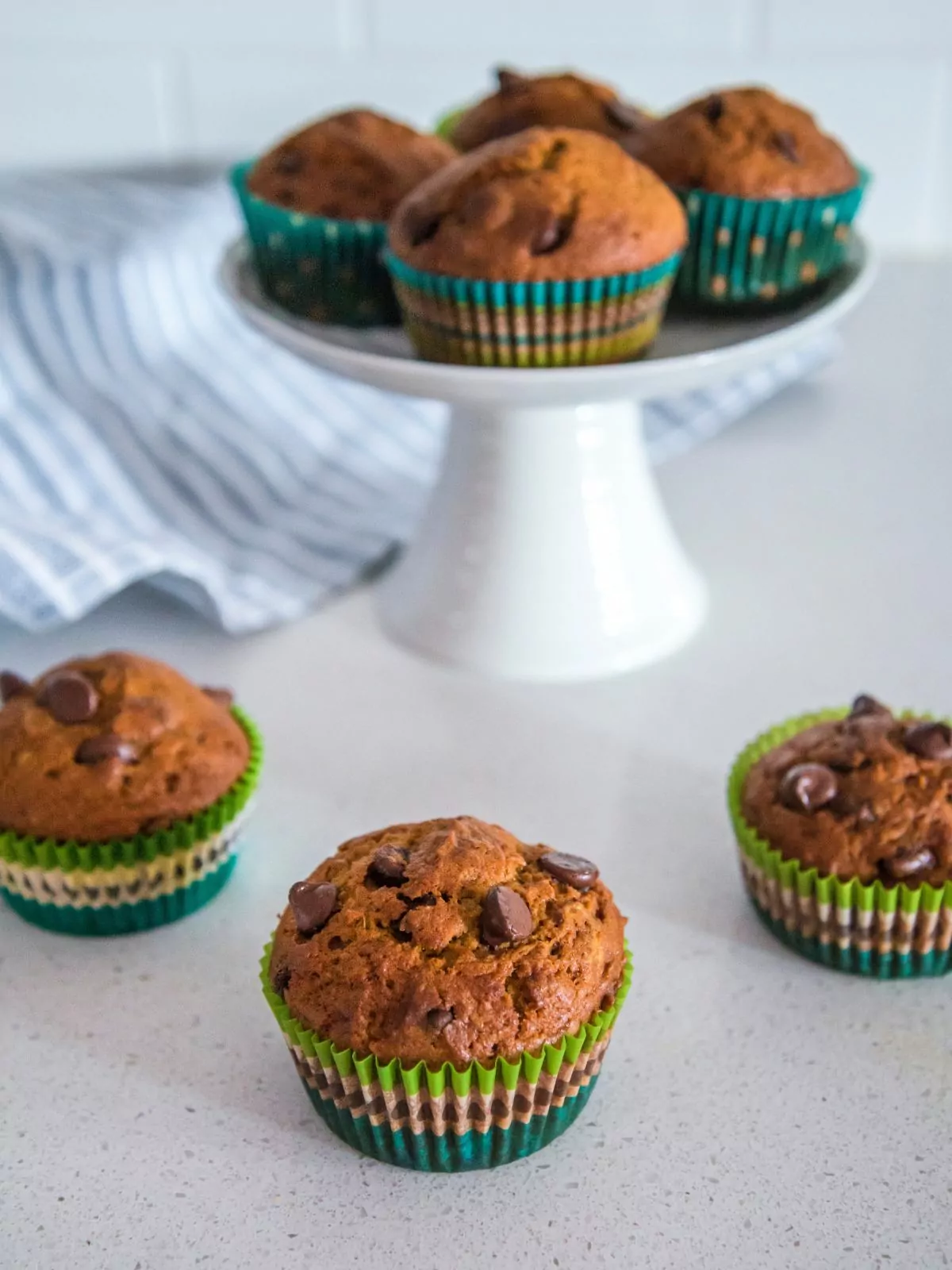 Pumpkin Chocolate Chip Muffins in green muffin liners