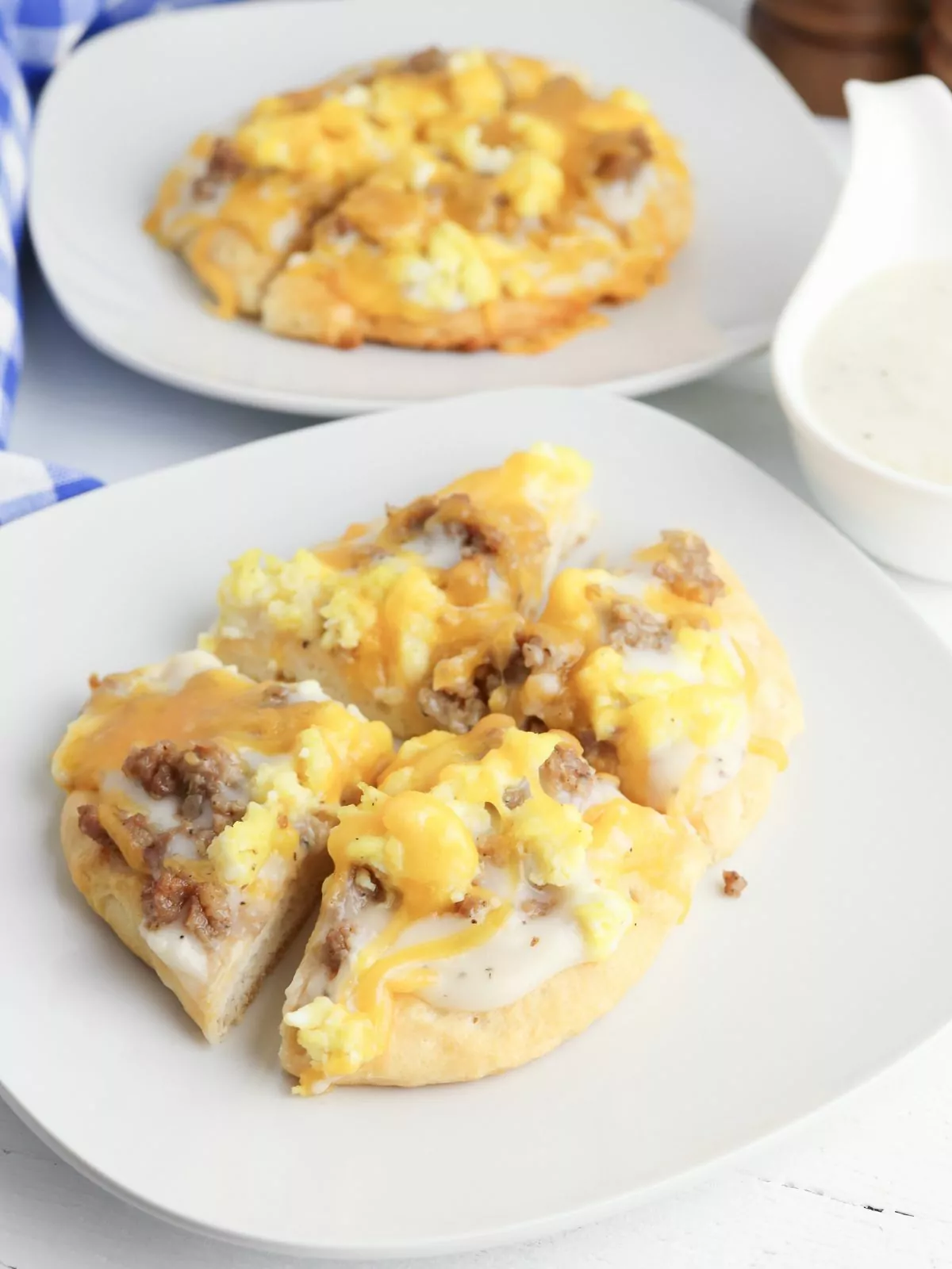 Breakfast Pizza Rolls cut into quarters and served on a white plate