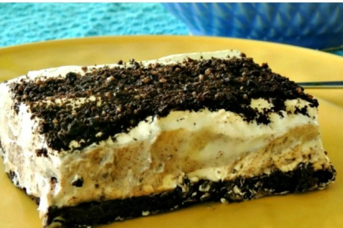Oreo pudding dessert with cookie crumb crust on yellow plate.