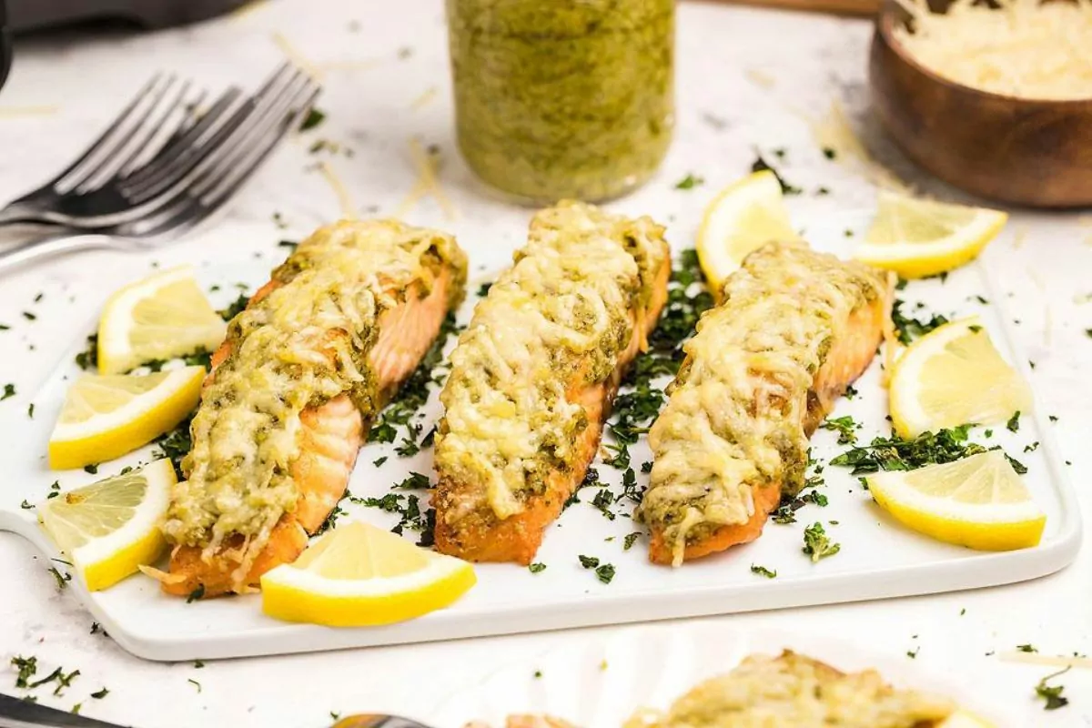 Salmon fillets with pesto and cheese.