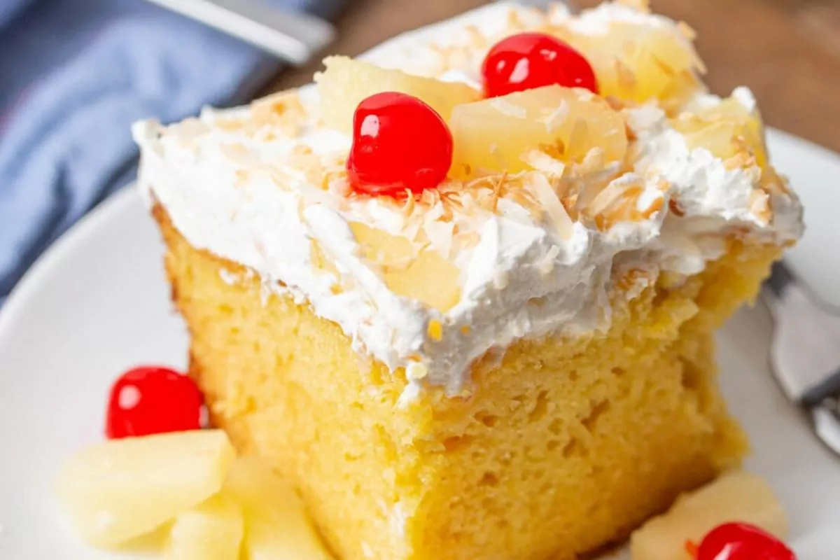 a yellow cake with jello and pineapple chunks.