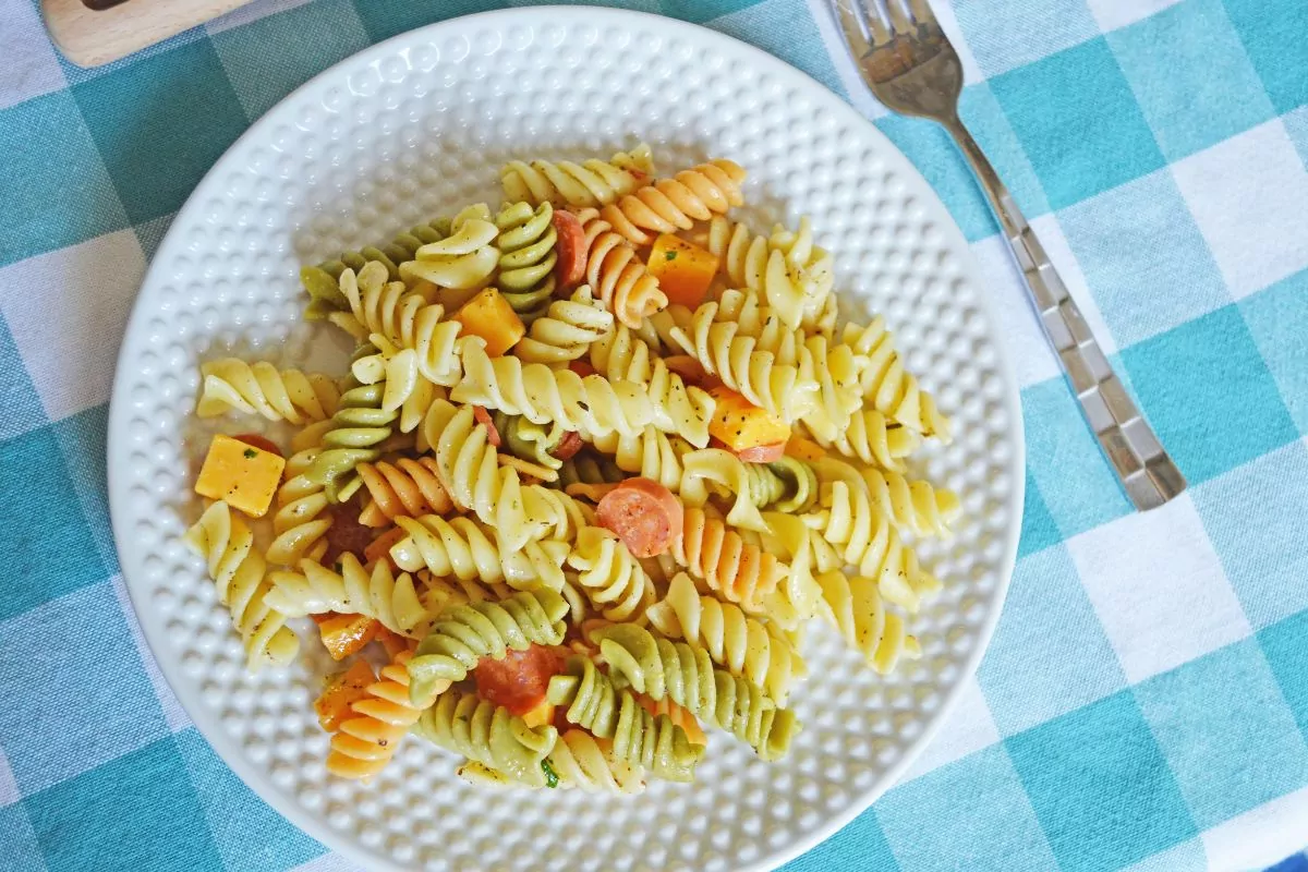 plate of Sunshine Pasta Salad on a teal and white checkered cloth.