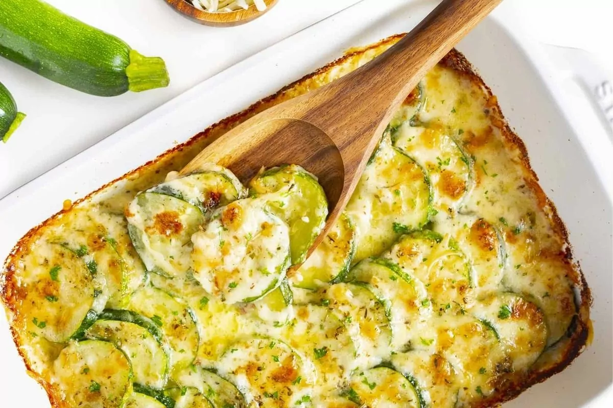 baked zucchini casserole with wooden spoon.