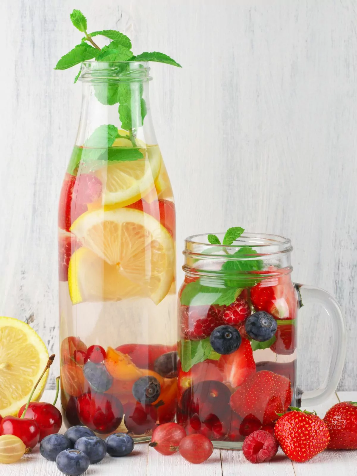 fruit and water in bottle and a mason jar glass.