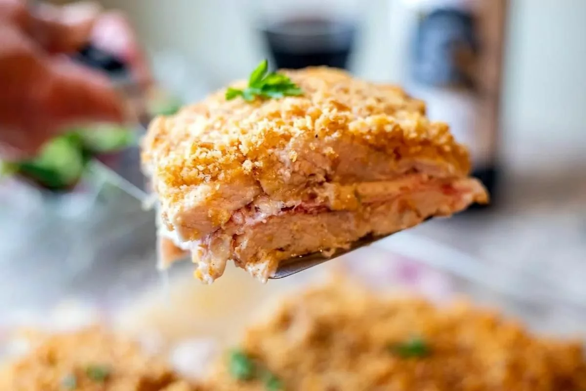 a spatula lifting a serving of casserole from a baking dish.