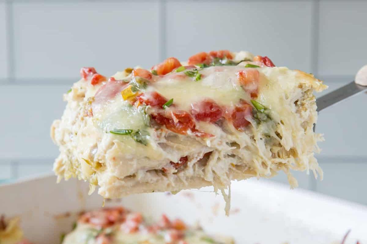 a serving of tortilla and chicken casserole being lifted by a spatula.
