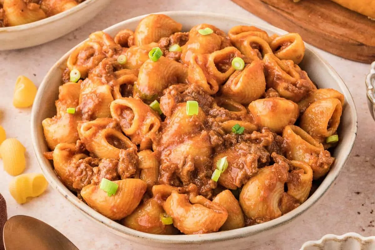 a bowl filled with old fashioned macaroni and tomato goulash.