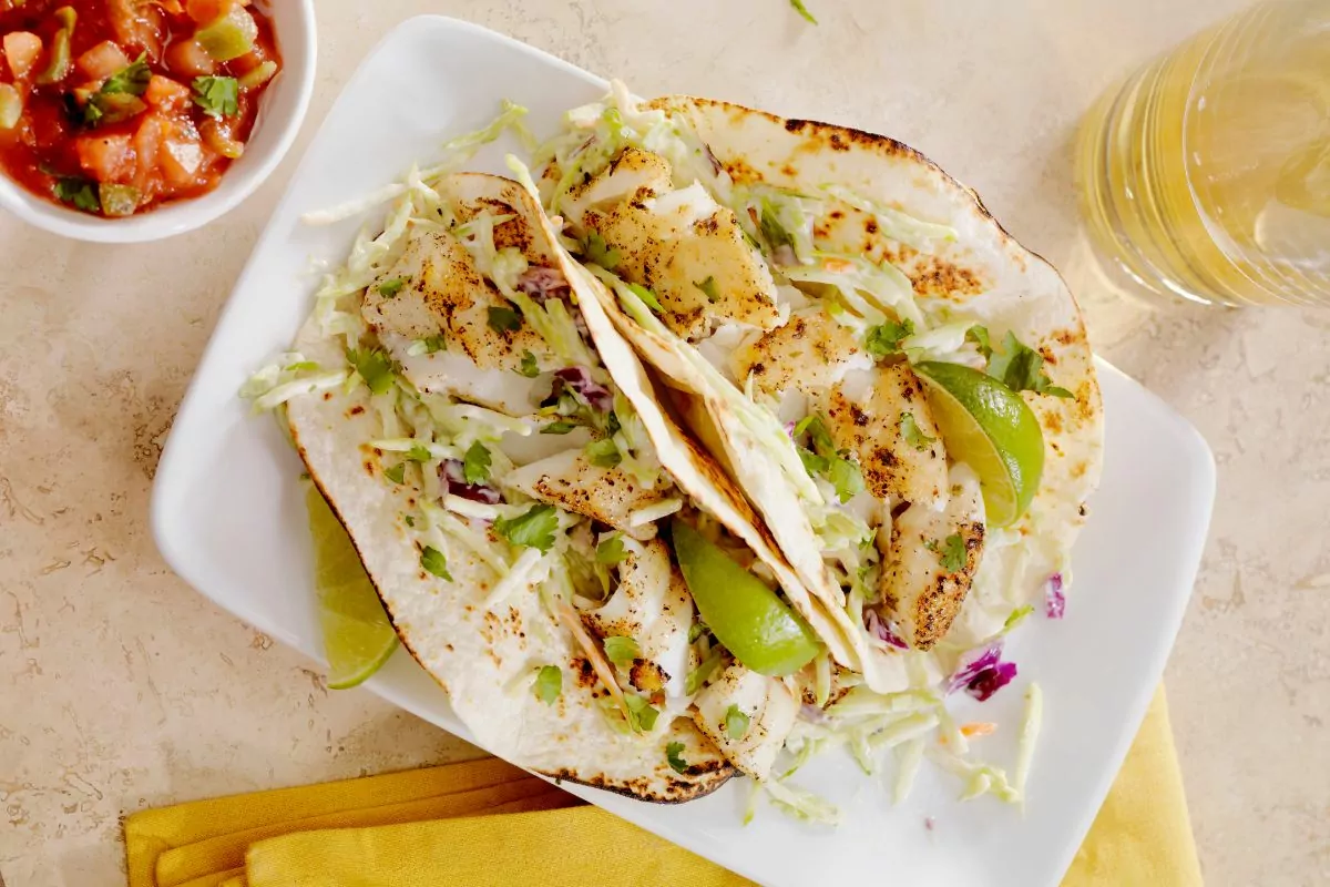 fish tacos on white plate.