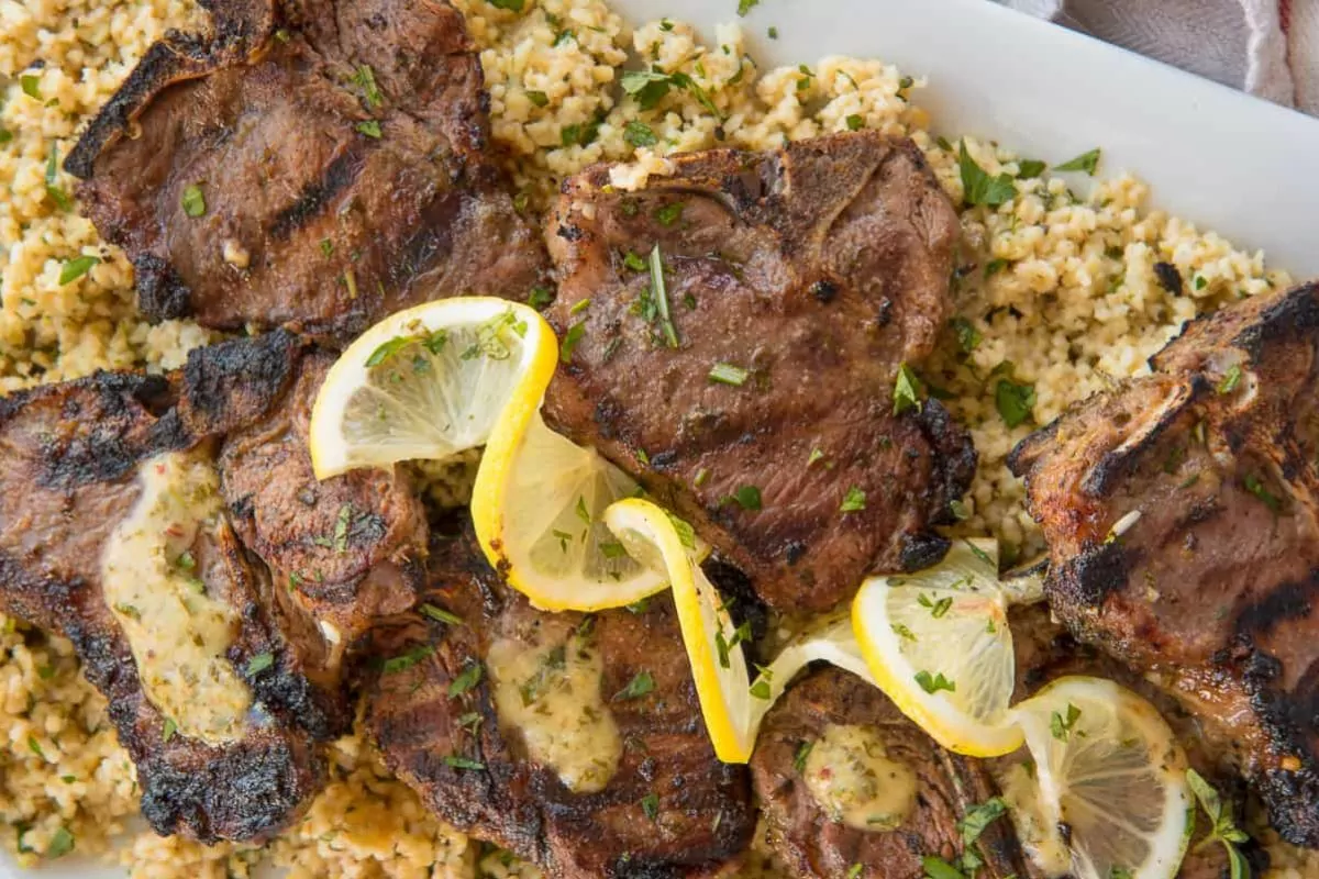 a platter of grilled lamb chops with garlic herb seasoning