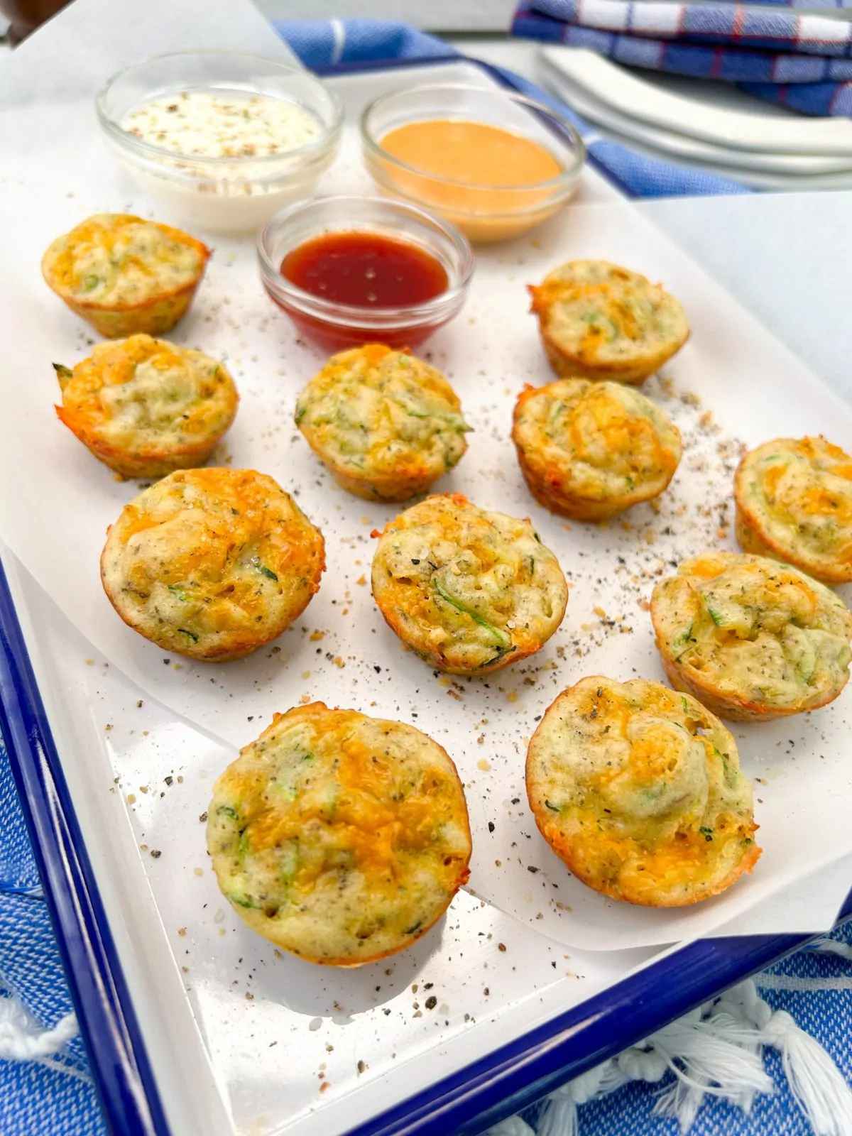 baked zucchini puffs on white tray.