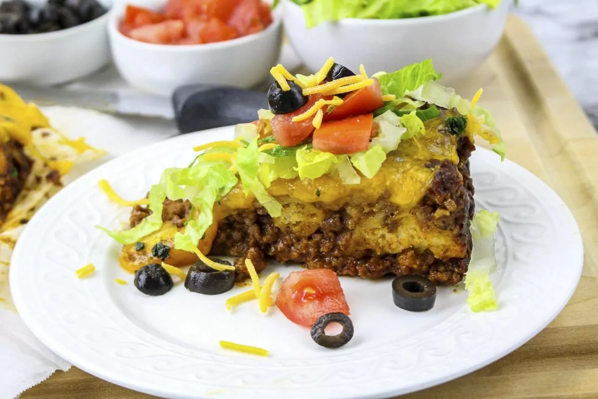 a serving of seasoned ground beef casserole with bubble up crust.