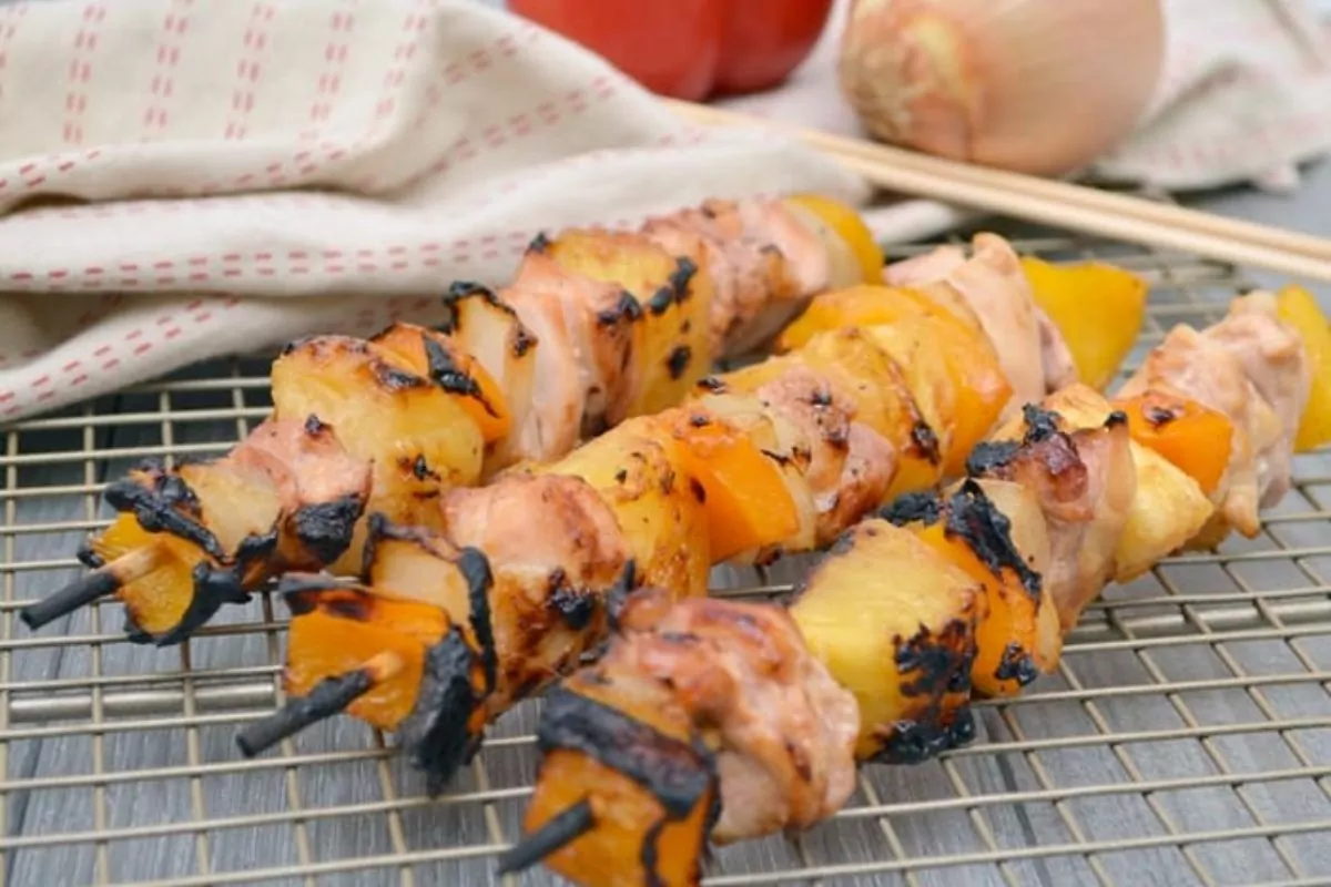 three skewers of pineapple and chicken, stacked on top of each other