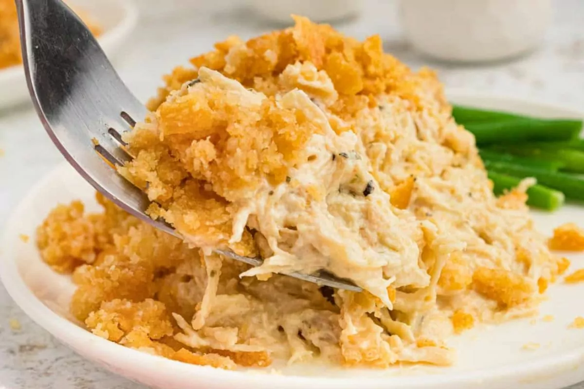 a serving of creamy chicken casserole topped with cracker crumbs on a plate.