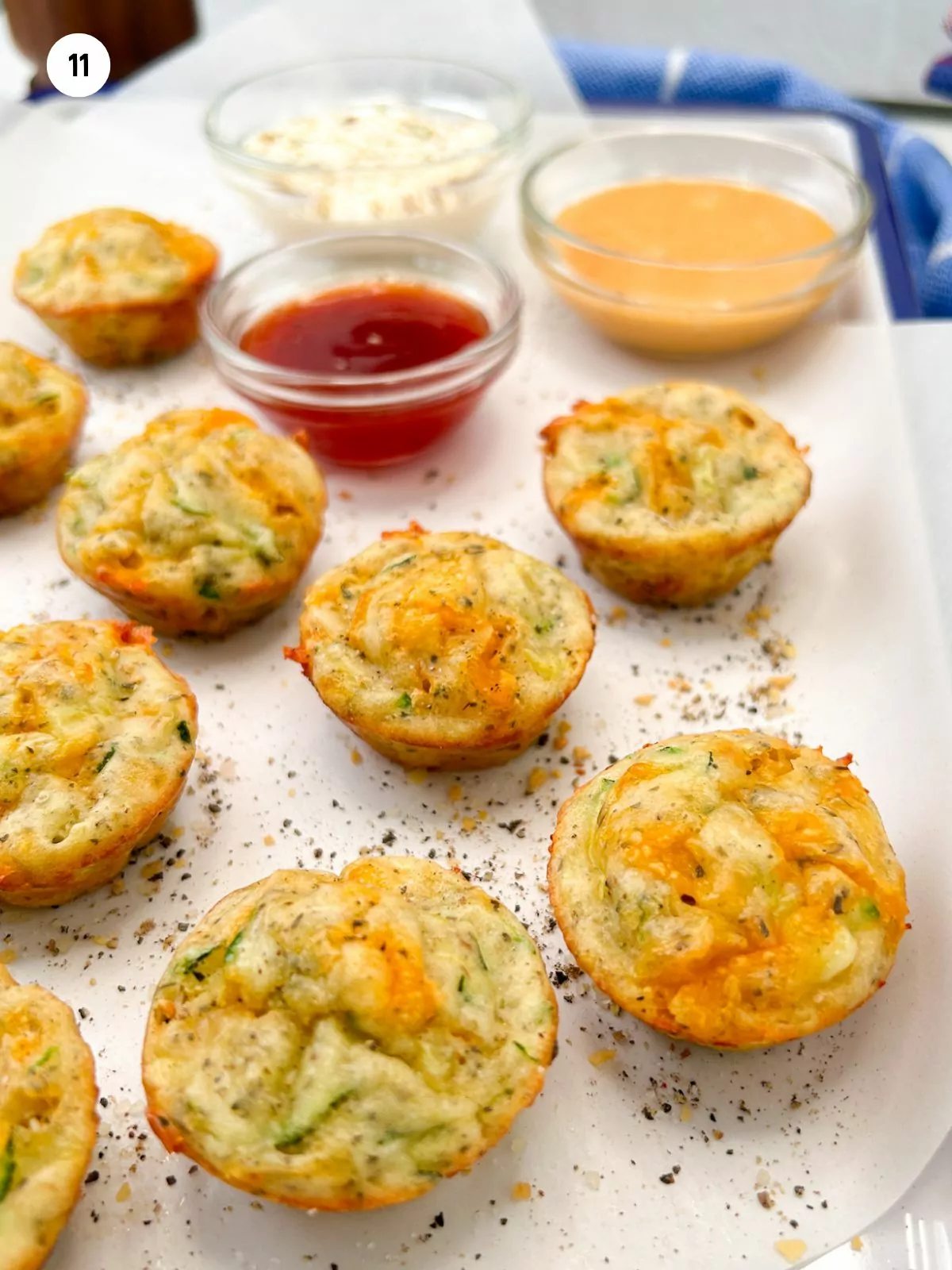 mini zucchini muffins served on tray with dipping sauces.