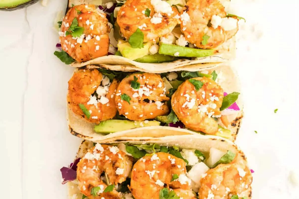 Soft taco shells filled with shrimp and cabbage