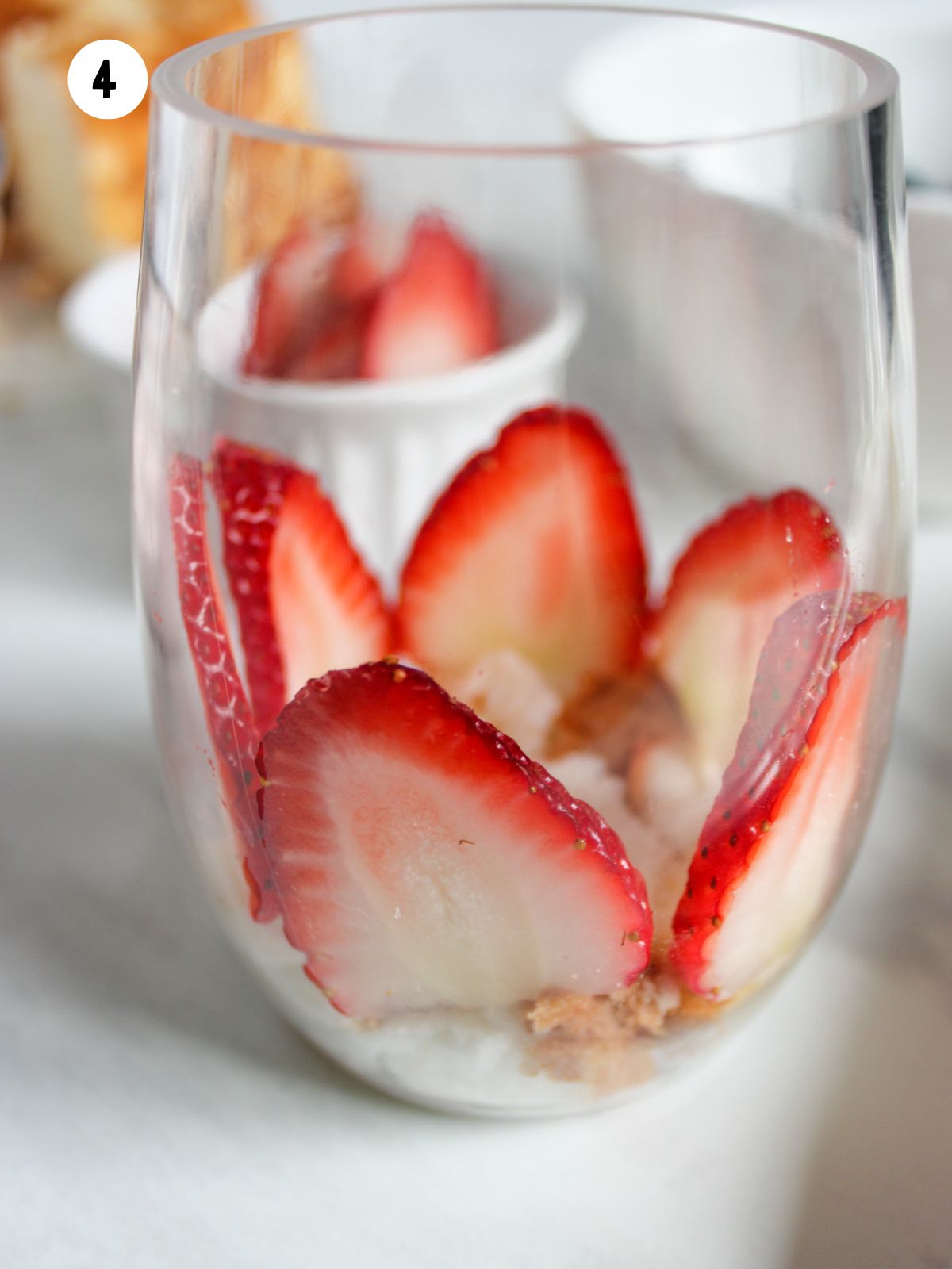 clear glass with a few sliced strawberries.