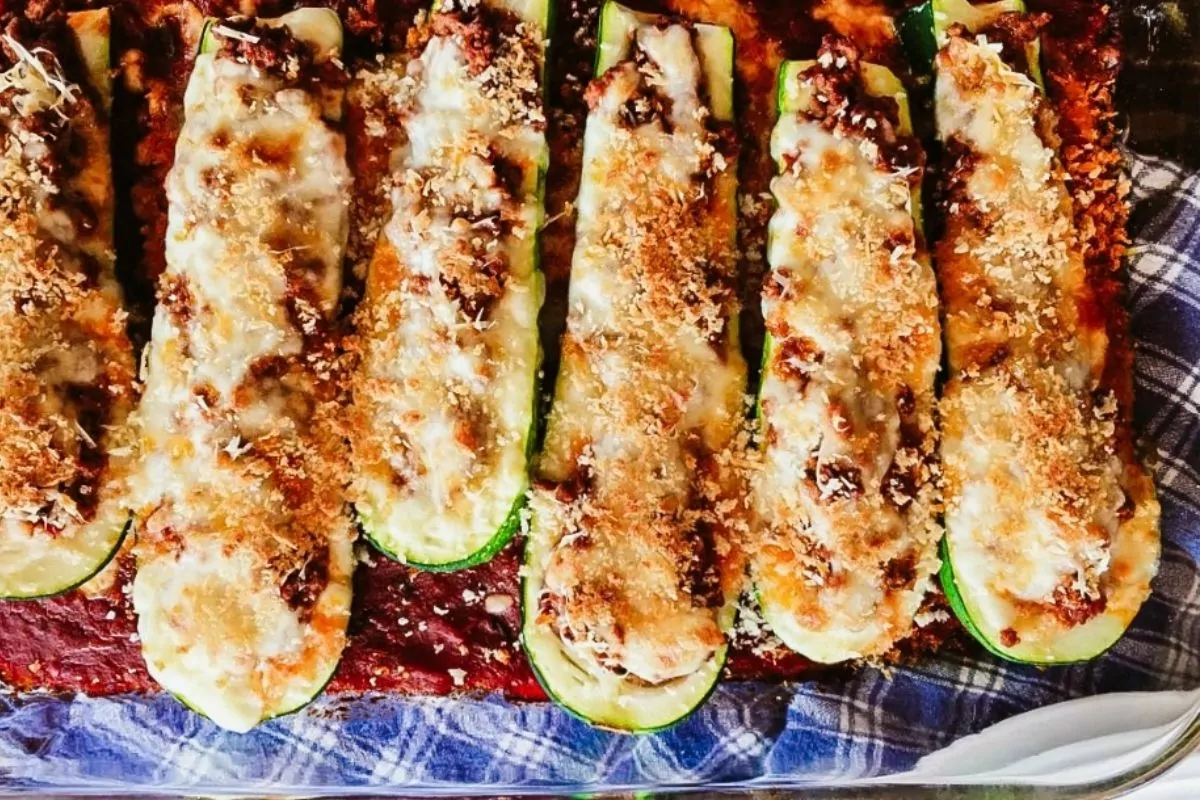 zucchini boats stuffed with meat and cheese baked in casserole dish.