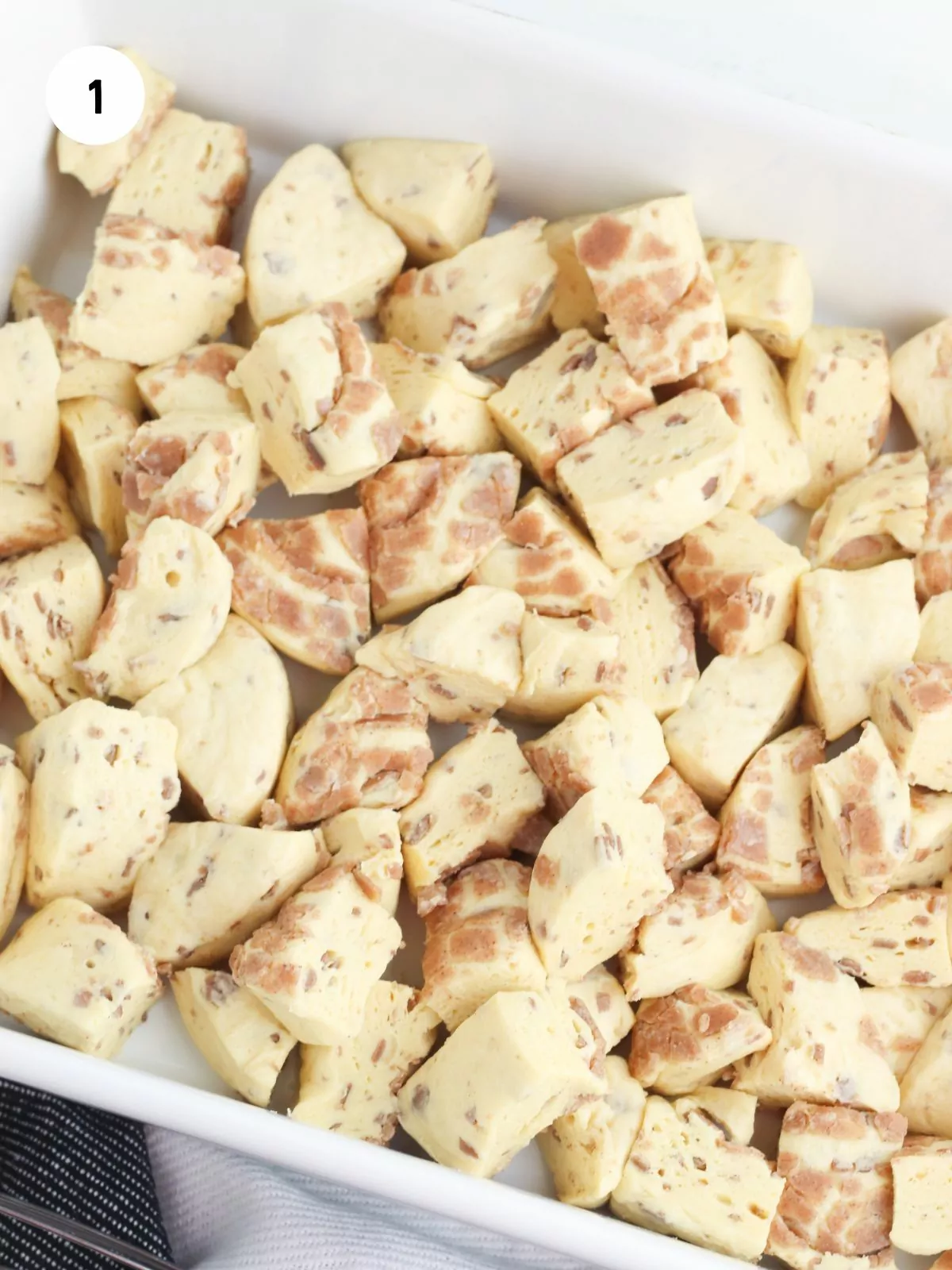 cut up cinnamon rolls in a casserole dish