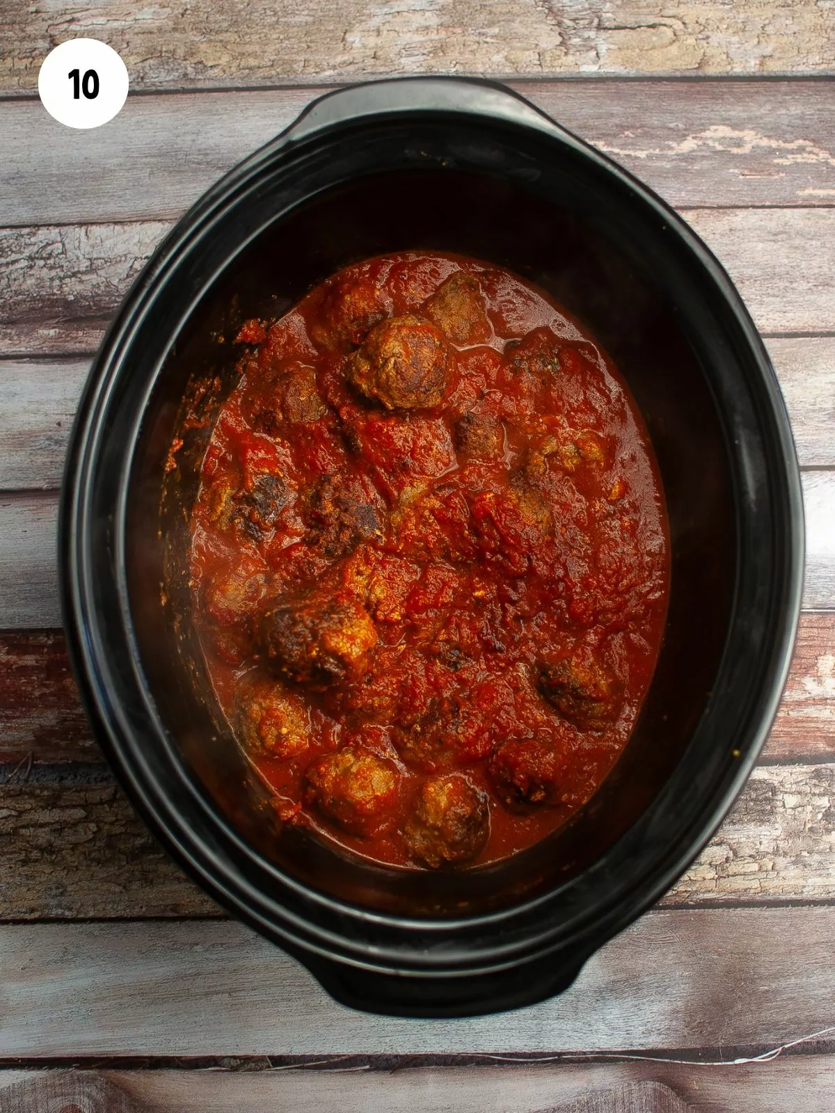 crock pot of cooked meatballs in sauce