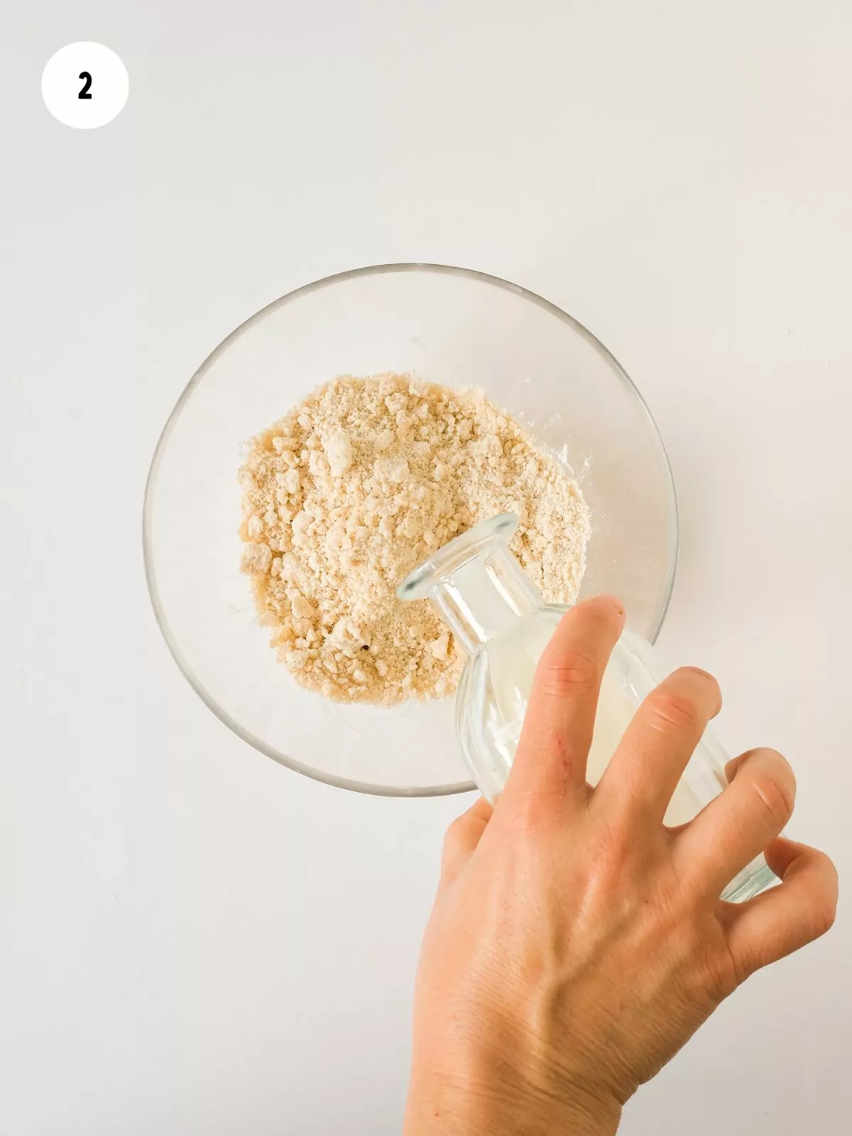 milk being poured into the flour mixture