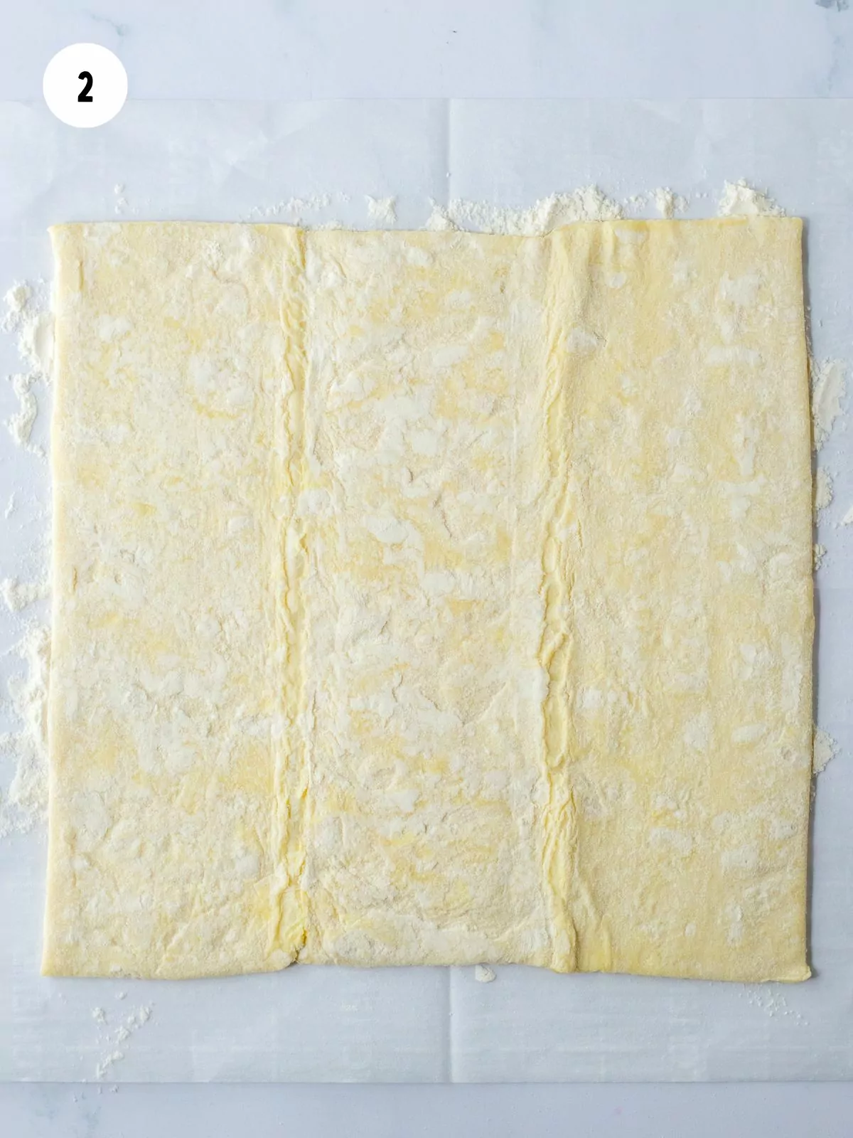 puff pastry sheets rolled out on a flour dusted piece of parchment