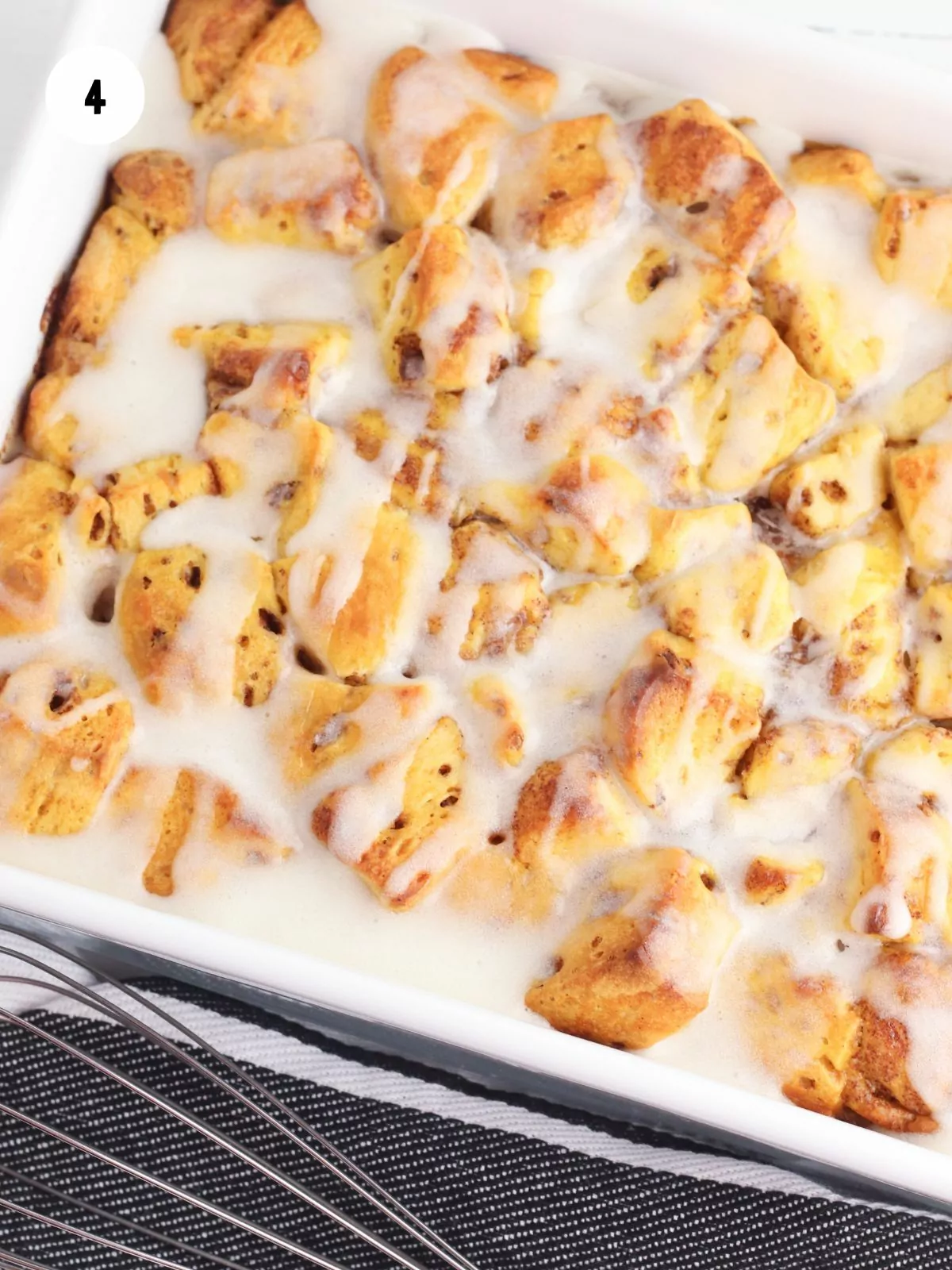 Pumpkin Cinnamon Roll Casserole with icing on it