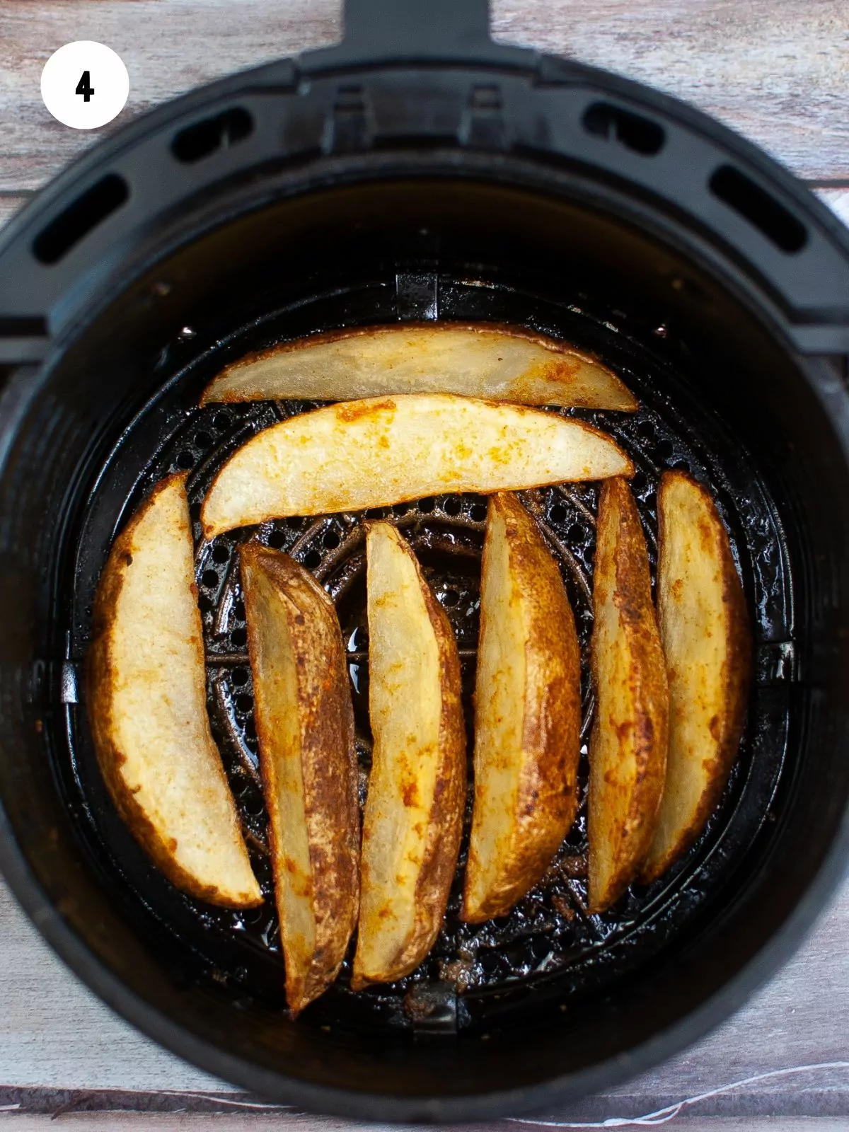 cooked potato wedges in the air fryer basket