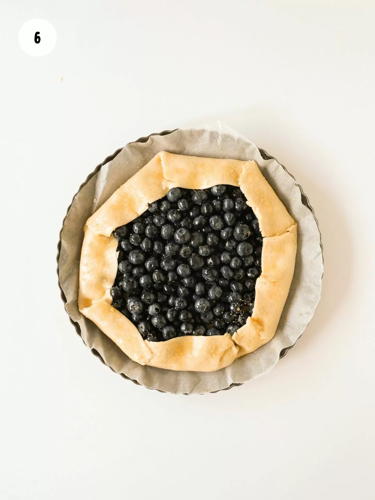 dough edges rolled over the blueberries