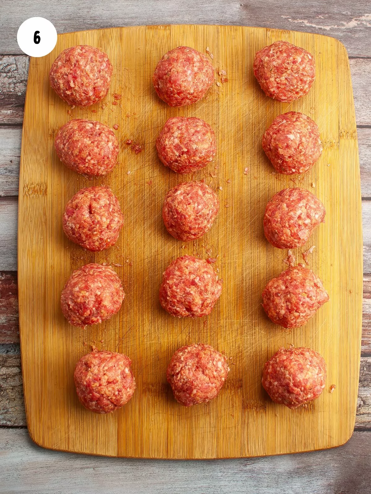 meatballs resting on a wooden cutting board