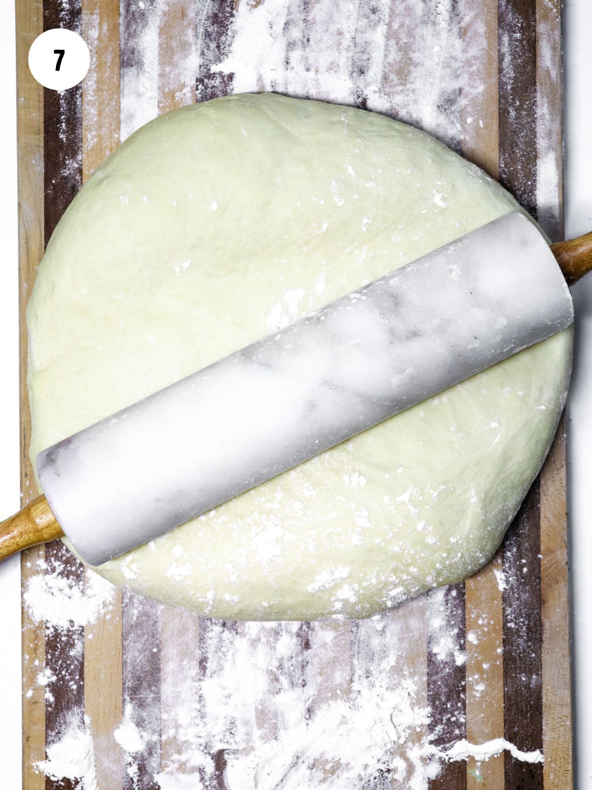 marble rolling pin rolling out ball of dough