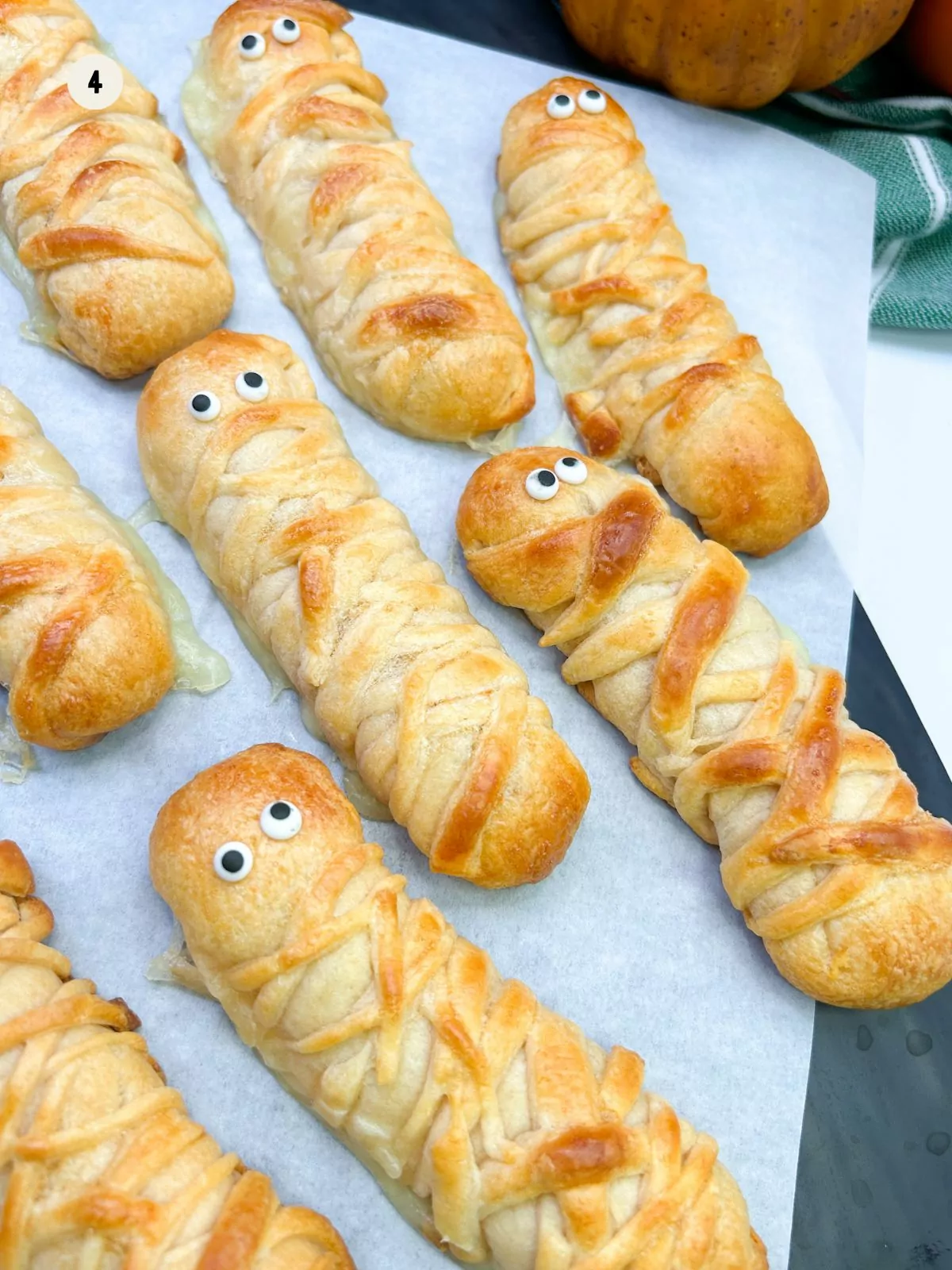 candy eyes on top of baked crescent rolls shaped like mummies.