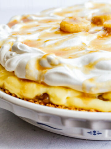 banana cream pie in ceramic pie plate.