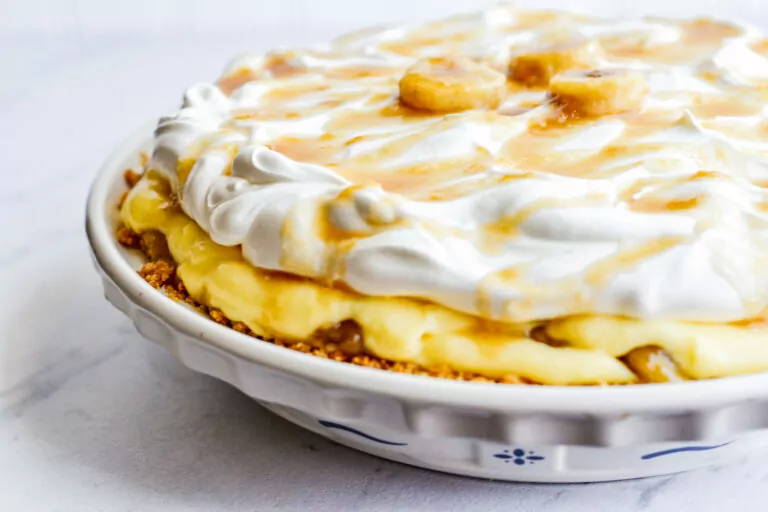 banana cream pie in ceramic pie plate.