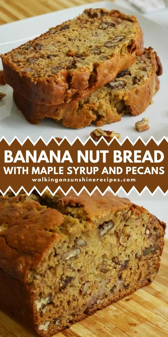 A freshly baked loaf of banana nut bread, golden brown with a slightly cracked top. Sliced walnuts and banana pieces are visible throughout.