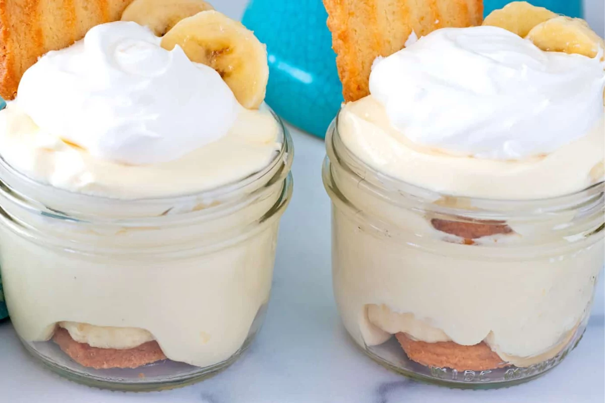 two jars with cool whip biscuit and banana on top