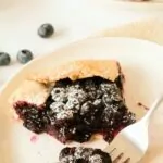 slice of blueberry galette with a bite on a fork