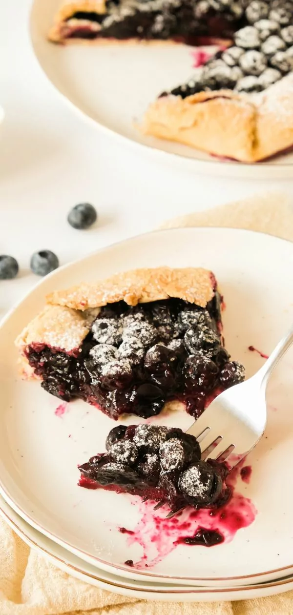 slice of blueberry galette with a bite on a fork