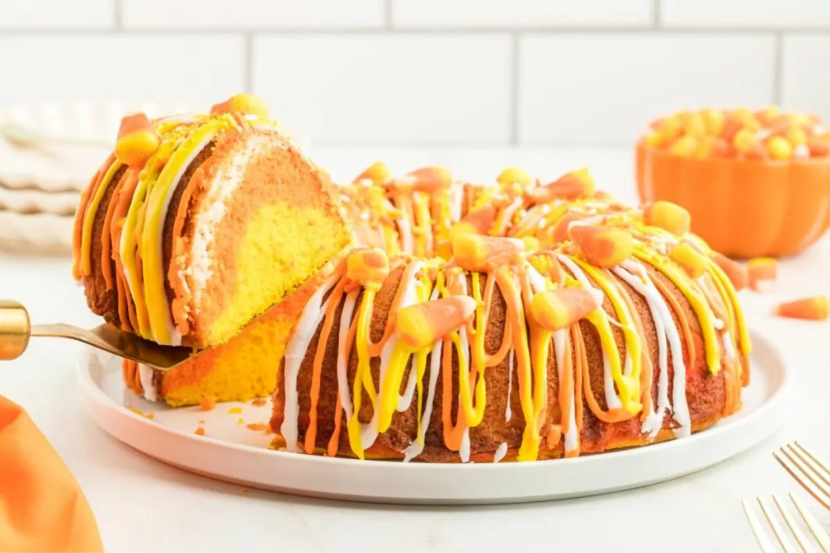 a bundt cake drizzle with white and yellow syrup and top with candy corn