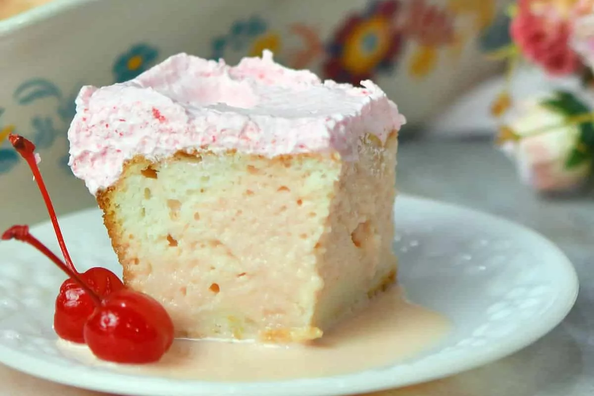 A piece of cake in a plate with cherry