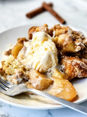 Cinnamon Roll Casserole with Heavy Cream and Apples served with ice cream