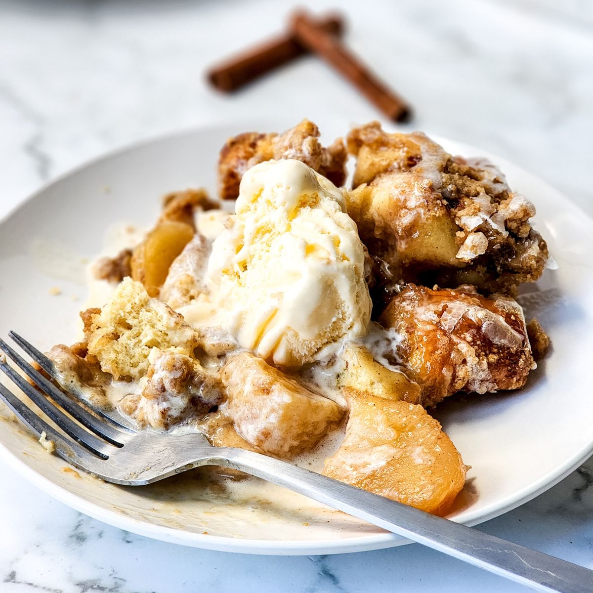 Cinnamon Roll Casserole with Heavy Cream and Apples served with ice cream