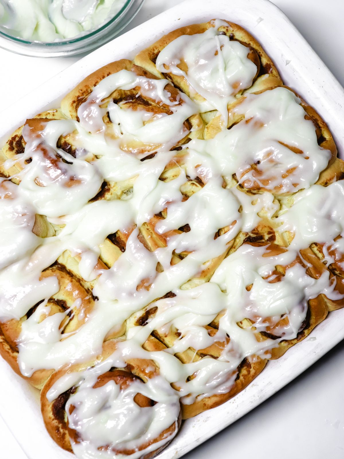 Pumpkin Cinnamon Rolls in a white baking dish