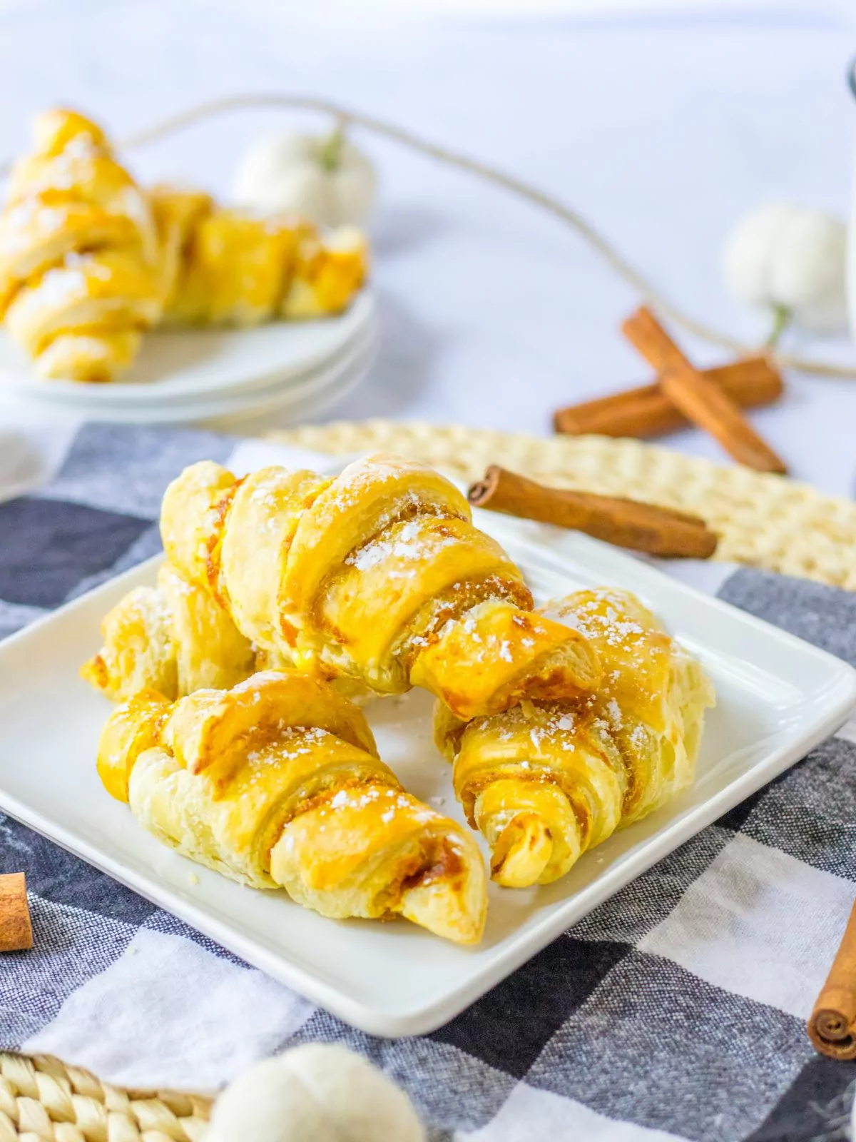 Pumpkin Puff Pastry crescents served on a white square plate