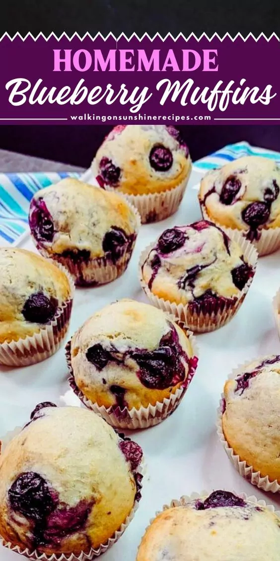 a tray of blueberry muffins in wrappers.