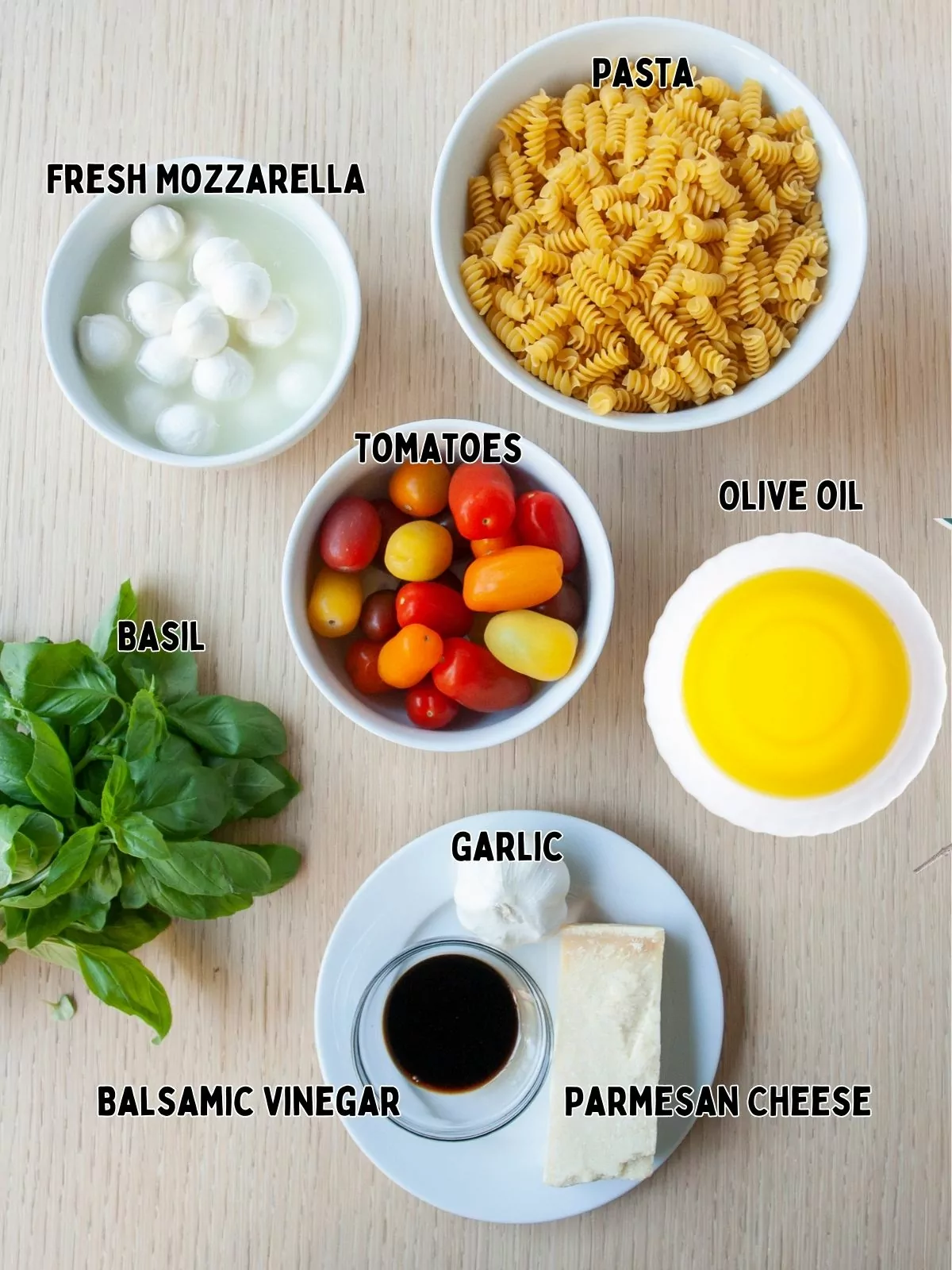 Ingredients, cheese, olive oil, balsamic vinegar, garlic, basil, pasta, tomatoes.