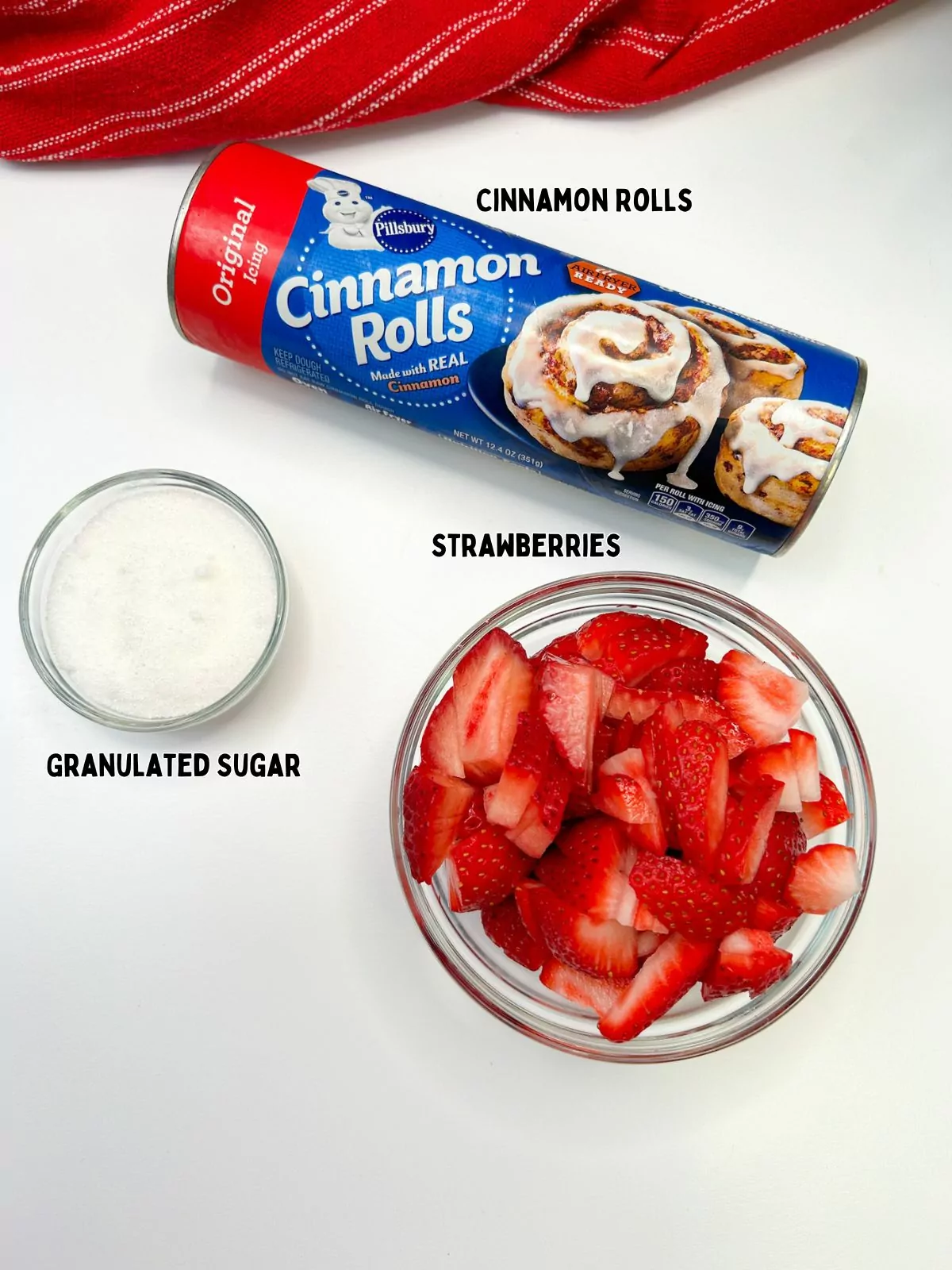 ingredients of sliced strawberries, granulated sugar and refrigerated cinnamon rolls.