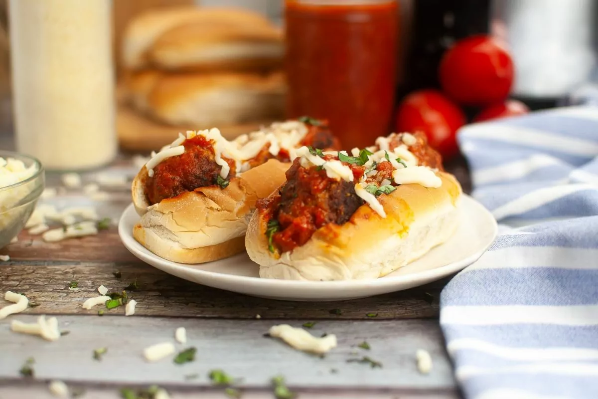 Meatball Sandwiches with ingredients in the background