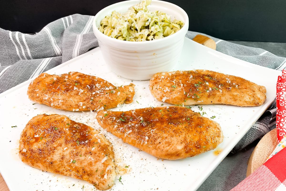 seasoned baked chicken cutlets on platter.